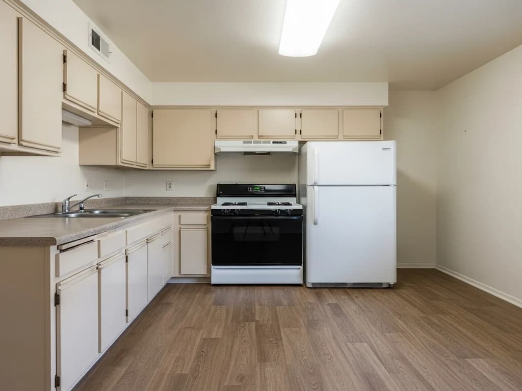 A clean, empty rental unit kitchen ready for a new tenant